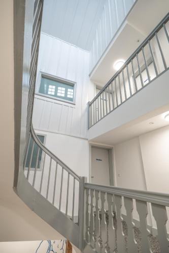 a spiral staircase in a building with a window at La Sauvage in Fribourg