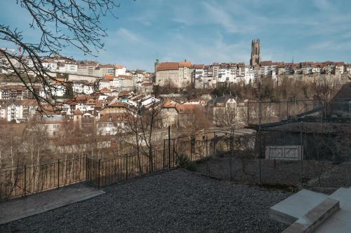 a view of a city from behind a fence at La Sauvage in Fribourg