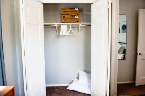 a room with a closet with a white door at Urban Cottage: Homey & Convenient in Huntington