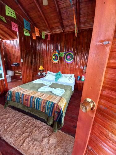 a bedroom with a bed in a wooden room at La Bota del Gigante in Gigante