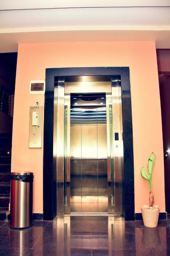 an elevator in a building with a potted plant at Faiz Residency in Rāmanāthapuram