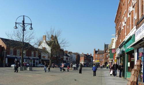 a group of people walking down a city street at Cosy Family Home in Long Eaton, Nottingham in Nottingham