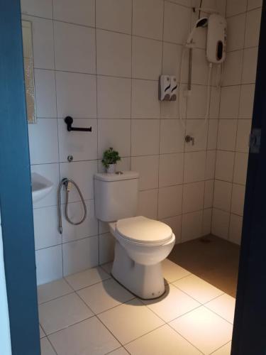 a bathroom with a toilet and a shower and a sink at Daddy's GuestHouse IMPERIO ALOR SETAR in Alor Setar