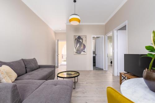 a living room with a couch and a table at HOUSE ANNA MARIA 2 in Mantoúkion