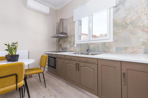 a kitchen with a sink and a table at HOUSE ANNA MARIA 2 in Mantoúkion