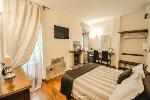 a bedroom with a bed and a fireplace at Case Brizi Assisi in Assisi