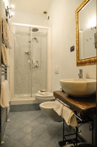 a bathroom with a sink and a toilet and a shower at Case Brizi Assisi in Assisi