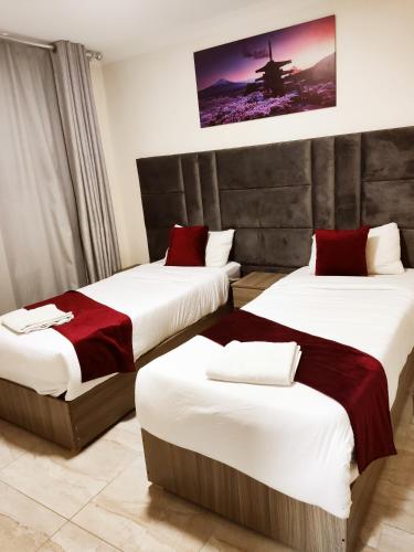 a hotel room with two beds in a room at Golden Plaza Hotel in Amman