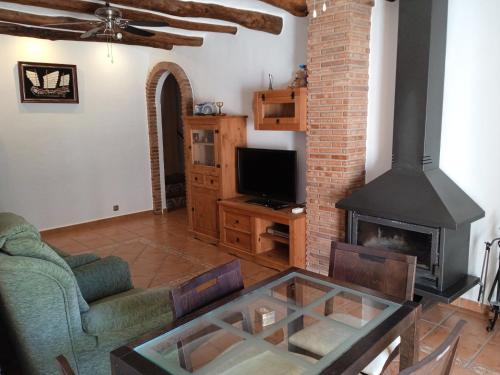 a living room with a couch and a fireplace at Casa Los Trillizos in Pampaneira