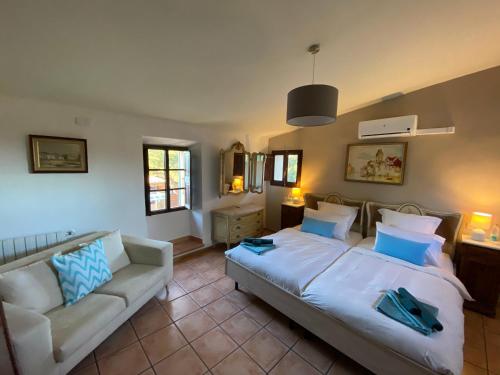 a bedroom with a large bed and a couch at Finca Sa Canova Agroturismo in Campos