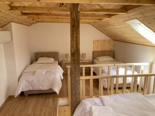 a room with two bunk beds in a attic at Sokaku i te Marreve GuestHouse in Gjirokastër