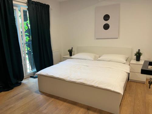 a white bed in a room with a window at Apartment Franky 6 , 1 st Floor in Zagreb