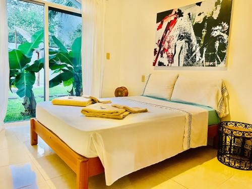 a bedroom with a bed with towels on it at Dolce Vita Caribe Villas in Playa del Carmen