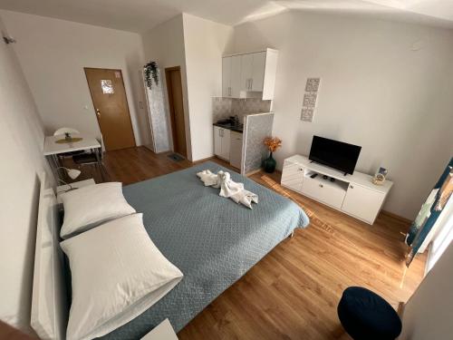 a bedroom with a bed with a towel on it at Apartments Mateljak in Gradac