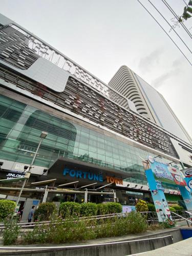 a tall building with a fortune lion sign on it at Sura Hostel and Coworking in Bangkok