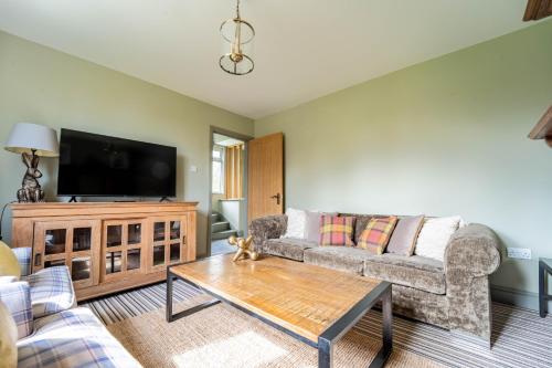 a living room with a couch and a tv at Suitable For Contractors 2 Double Beds and Sofa Bed Private Parking in Harlow
