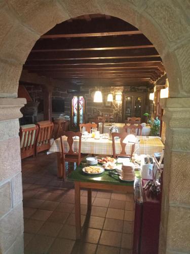 a dining room with a table with food on it at Casa Rural S. Antonio in Menaza
