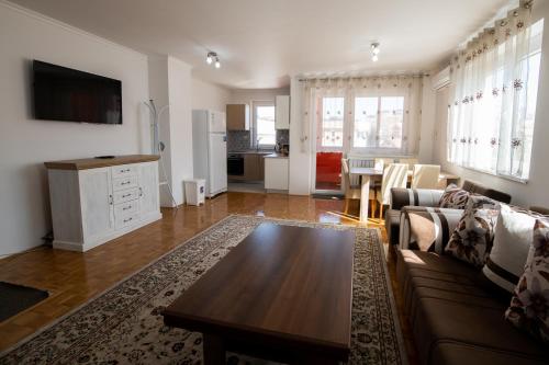 a living room with a couch and a table at Markeeto apartments in Ilijaš