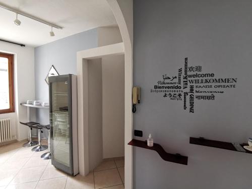 a room with a refrigerator with words on the wall at BeB I PORTICI in Cernobbio