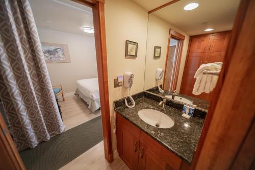 a bathroom with a sink and a mirror at Lakeside 1496 in Keystone