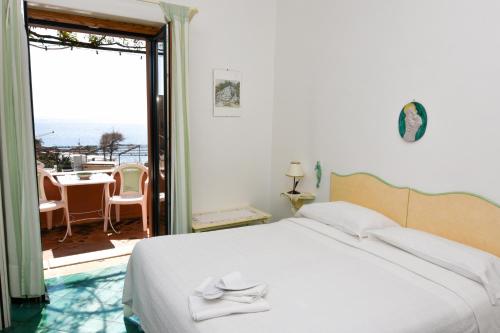 a bedroom with a bed and a view of the ocean at Villa Maria Antonietta in Positano