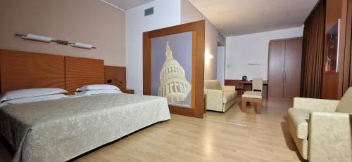 a bedroom with a bed with a picture of a building at Bella Italia Palace Hotel in Novara