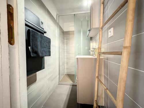 a small bathroom with a sink and a mirror at Gorges du Tarn - Maisonnette à flanc de falaise in Sainte-Énimie