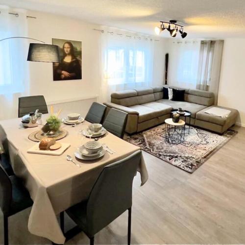 a living room with a table and a couch at Im Herzen der Altstadt in Vaihingen an der Enz
