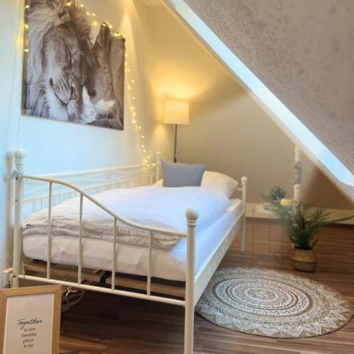 a bedroom with a bed with lights on the wall at Im Herzen der Altstadt in Vaihingen an der Enz