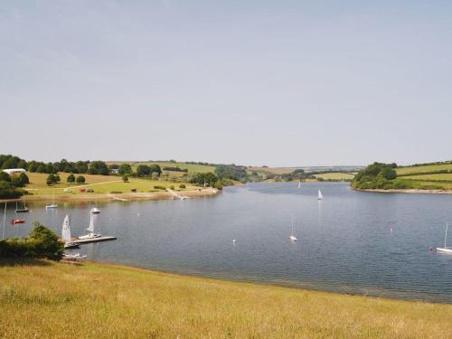 a river with boats in it with a dock at Valley Lodge in Tiverton
