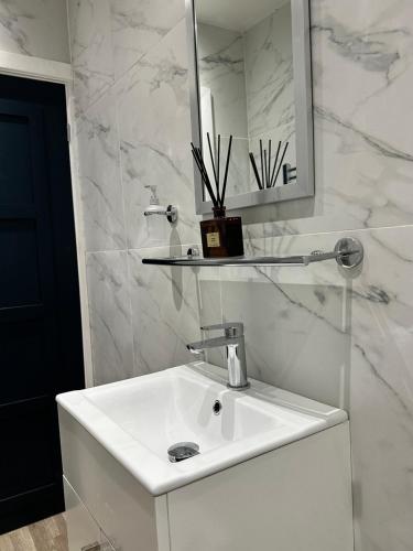 a white bathroom with a sink and a mirror at No 3 ,luxury 2 bed 1st floor apartment with free parking,Lytham St Annes in Saint Annes on the Sea