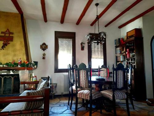 a room with a table and chairs and a fireplace at Ενοικιαζόμενη Παραδοσιακή κατοικία Σαν Παραμύθι in Volakas