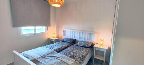 a small bedroom with a bed and two night stands at Casares Cozy Apartment in Casares