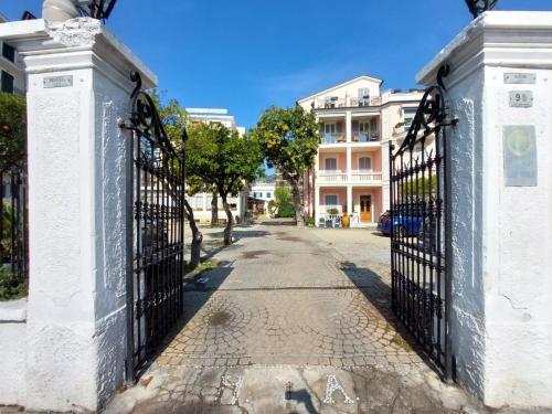 a gate in a street with a building at Hotel Aida in Alassio