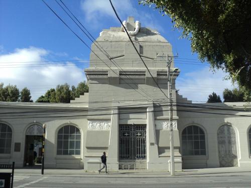 a man walking in front of a building at VALYAK rent apart hotel - Servicios Integrales in Punta Arenas