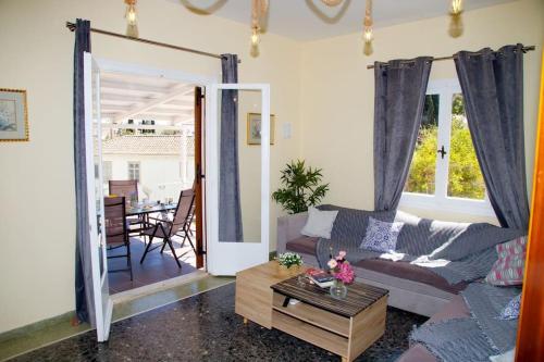 a living room with a couch and a table at Spentza Home in Spetses