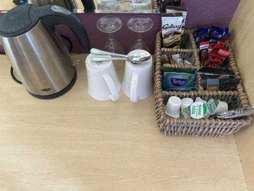 a table with two baskets of food and a blender at Llety Betws in Betws-y-coed