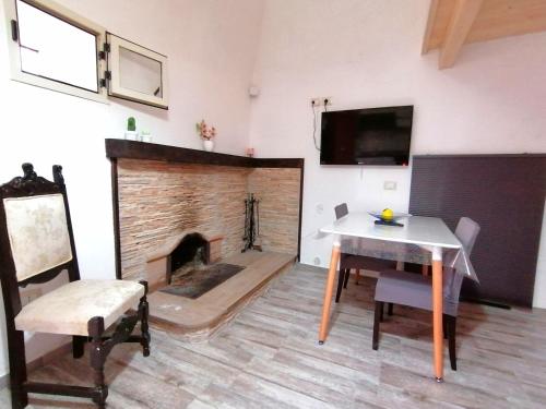 a living room with a table and a fireplace at DIMORA HELIANTHUS in Salandra