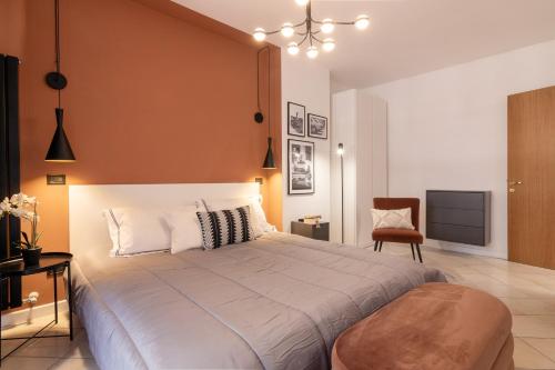 a bedroom with a large bed and a chair at Apartment with Jacuzzi Suite and 100-m2 terrace in Perugia