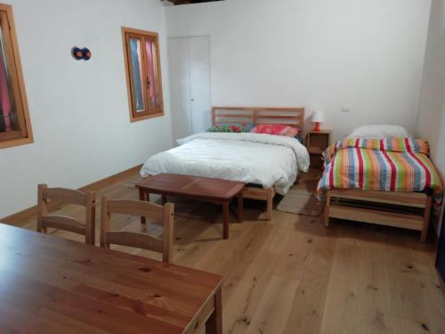 a bedroom with two beds and a table and chairs at CorteZecchina in Piove di Sacco