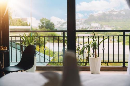 a view of a balcony with a table and chairs at GREENECO DA LAT HOTEL - Khách sạn Green Eco Đà Lạt in Da Lat
