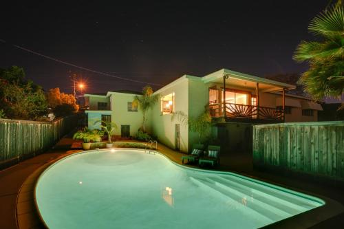 a swimming pool in front of a house at night at Charming Spring Valley Retreat with Private Pool! in Spring Valley