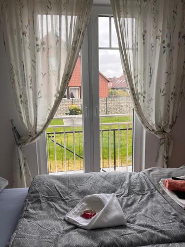 a bedroom with a bed and a large window at Casa Rehman in Ratzeburg