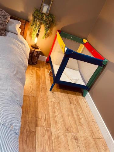 a bedroom with a bed and a play house at Healing Pastures Farm in Llanbrynmair