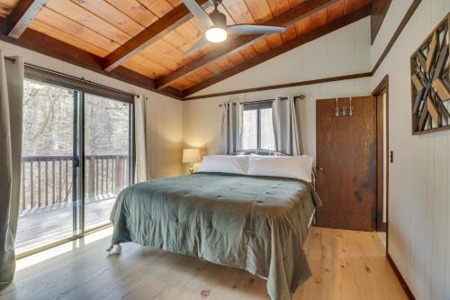 a bedroom with a bed and a large window at McGaheysville Vacation Rental Yard and Fire Pit! in McGaheysville