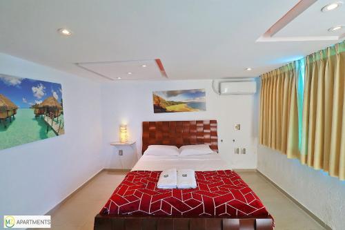 a bedroom with a bed with a red bedspread at Beautiful 4BR duplex penthouse in Rio de Janeiro