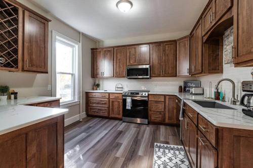 a kitchen with wooden cabinets and a sink and a stove at Eagles Landing in La Crosse