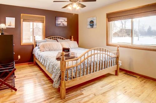 a bedroom with a bed and a window at Waterfront House on Chippewa Lake Channel in Evart
