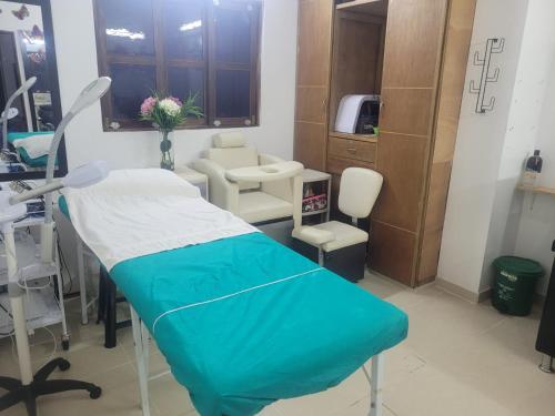 a hospital room with a bed and a chair at Hotel Campestre Villa Nico in Bochalema