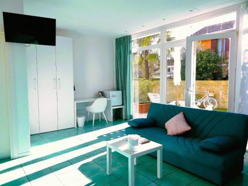 a living room with a blue couch and a table at Villa Marina in Venice-Lido